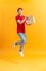 Delivery employee man hold brown craft paper bag for takeaway and jumping