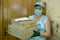 Delivery of food to the house in the face of a pandemic. Pizza in cardboard boxes brought a deliverywoman