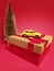 delivery of gifts  by couriers for Valentine's Day, yellow car on a red background, concept of a taxi and delivery