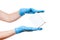 Delivery hands in blue sterile latex gloves holds white label cardboard box.