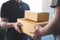 Delivery mail man giving parcel box to recipient, Young owner accepting of cardboard boxes package from post shipment, Home