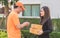 Delivery man asking woman to sign mobile for the delivery