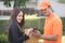 Delivery man asking woman to sign mobile for the delivery