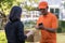 Delivery man asking woman to sign mobile for the delivery