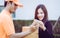 Delivery man asking woman to sign mobile for the delivery