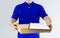 Delivery man in blue uniform and holding blank clipping board wi