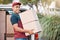 Delivery man, box and courier service with package, shipment or parcel from van transportation outdoor. Cargo vehicle