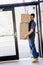 Delivery man carefully carrying stack of boxes