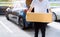 Delivery man carrying cardboard box for sending to receiver customer by transportation