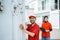 delivery man closing container door against background smiling female worker