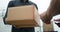 Delivery man delivering package to customer, close up at and and box