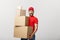 Delivery man doing surprise gesture holding cardboard boxes.