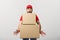 Delivery man doing surprise gesture holding cardboard boxes.