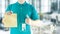 Delivery man hand holding paper bag in blue uniform and icon media for delivering package order online fast food delivery service