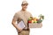 Delivery man holding a crate filled with groceries and clipboard