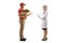 Delivery man holding groceries in a paper bag and talking to a female doctor