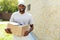 Delivery Man. Portrait Of Smiling Courier With Box Package