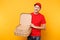 Delivery man in red cap, t-shirt giving food order pizza boxes isolated on yellow background. Male employee pizzaman or