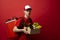 Delivery man in red uniform holds craft cardboard box with food isolated on white background, studio portrait. Service