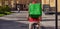 Delivery man with refrigerator bag riding away on bicycle