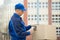 Delivery Man Scanning Cardboard Boxes With Barcode Scanner