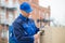 Delivery Man Scanning Cardboard Boxes With Barcode Scanner