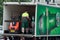 Delivery man unloading Heineken goods from drinking delivery truck parked in the street near restaurant