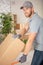 Delivery man uses trolley full cardboard boxes