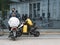 Delivery Man Waiting With Smartphone Near Restaurant