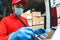 Delivery man wearing face protective mask to avoid corona virus spread - Young express courier working during coronavirus outbreak