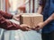 a delivery man in a work uniform delivers a postal package