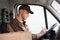 Delivery Man Writing On Clipboard In Truck