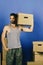 Delivery and moving in concept: fit guy with carton