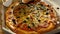 Delivery of pizza in a box. A delicious juicy and beautiful pizza is cut with a round knife. The family eats pizza with