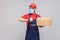 Delivery on quarantine. Ontime service! man with surgical medical mask in blue uniform and red t-shirt standing, holding delivery