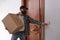 Delivery senior man ringing the door bell holding a package
