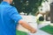 Delivery service courier standing in front of the house with box