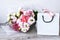 Delivery service packing bouquet flowers pink white background gift shipping. Beautiful romantic composition with flowers. St.