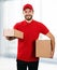 delivery service - young smiling deliveryman with cardboard boxes