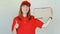 Delivery smiling woman in red uniform. Female in cap, t-shirt, jeans working as courier or dealer holding cardboard