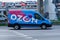 Delivery van of the Russian online store Ozon in motion on the street. Blue mini van truck for delivery rushing on city highway