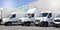 Delivery white vans in service van trucks and cars in front of the entrance of a warehouse distribution logistic