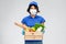 Delivery woman in face mask with food in box