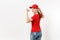 Delivery woman in red uniform isolated on white background. Professional pretty female in cap, t-shirt, jeans working as