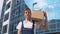 A delivery worker holds a box on his shoulder, looking at the camera, and then walks to the side. Delivery of goods to