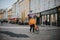 Delivery worker of Lieferando stands with their bicycle on a busy street in Klagenfurt, Austria