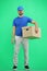 The deliveryman, full-length, on a green background, with a box