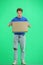 The deliveryman, full-length, on a green background, with a box