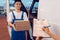 Deliveryman gives parcel to female recipient