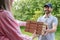 Deliveryman handing grocery or pizza to woman home.